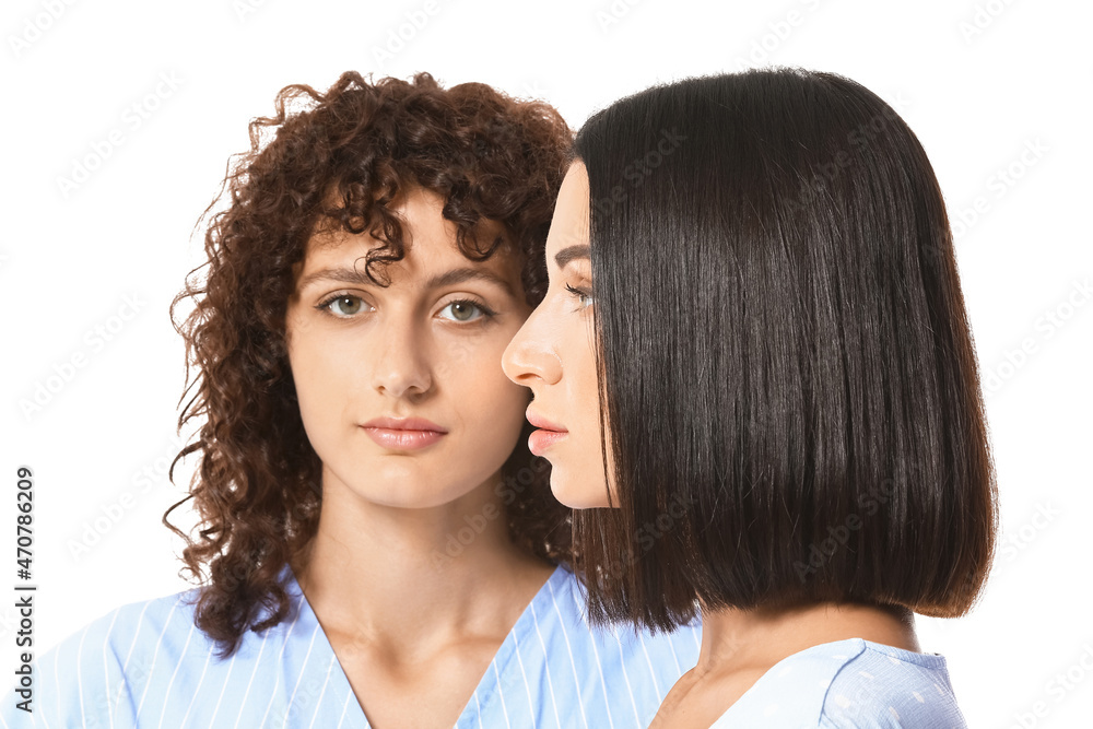 Portrait of sisters on white background
