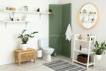 Poster - Interior of restroom with toilet bowl and shelves with bathroom accessories