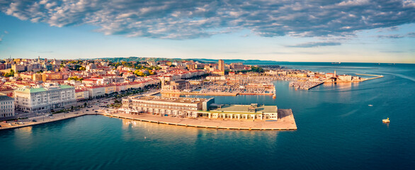 Wall Mural - View from flying drone of quay of Trieste city, Italy, Europe. Panoramic morning view of Tourist attraction - Cruise Pier Trieste with Molo Teresiano on background. Traveling concept background.