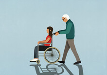 Senior Man Pushing Girl In Wheelchair
