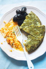 Wall Mural - Spinach potato tortilla with vegetable salad and black olives