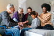© NDABCREATIVITY - Three generation happy multiethnic family group at home