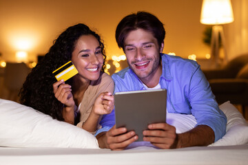 Wall Mural - Spouses Using Credit Card And Tablet For Shopping In Bedroom