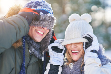 Couple having fun in winter scenery and snow