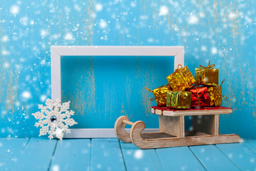 Wall Mural - New Year's gifts on a sled and a frame. Christmas card.