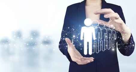 Human resources and team management concept. Two hand holding virtual holographic Human, Leader icon with light blurred background. Human search.Leader and CEO.