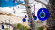 © Ievgen Skrypko - Amulets against evil eye hanging on tree in front of sandy mountain in Cappadocia, Turkey