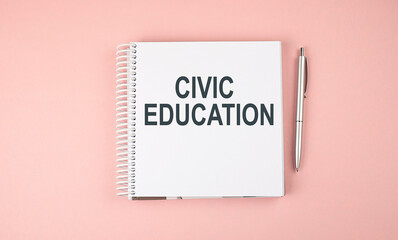 CIVIC EDUCATION text on notebook with pen on the pink background