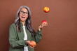 Photo of impressed old grey hairdo lady juggle wear shirt eyesight isolated on brown color background