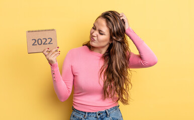 Wall Mural - hispanic pretty woman smiling happily and daydreaming or doubting. calendar concept