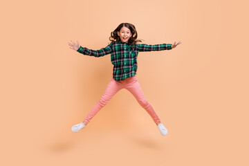 Poster - Photo of funky adorable schoolgirl wear plaid outfit jumping high like star smiling isolated beige color background