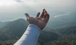 Hands outstretched to receive natural light and mountain views