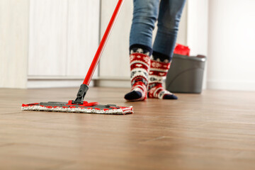 Wall Mural - Christmas cleaning in socks, the floor with a free space 