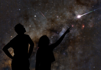 Wall Mural - silhouettes of father and daughter under starry skies.