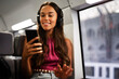 © Jelena - Young woman travelling by train. Beautiful girl listening the music while travel..