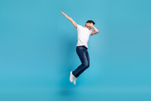 Full Body Photo Of Young Man Jump Up Close Eyes Hands Dav Performance Isolated Over Blue Color Background