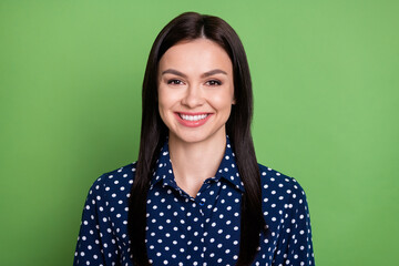 Wall Mural - Photo of happy nice young woman good mood face wear blue dotted shirt isolated on green color background