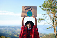 Emotionless South American Showing Placard With Call For Saving Planet