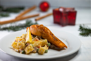 Wall Mural - Traditional Christmas dinner in Czech Republic - salmon fillet with potato salad