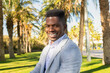 © ADDICTIVE STOCK - Happy black man in stylish clothes sitting in park