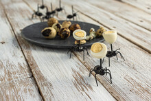 Black Ants Crawling On Table With Plate With Quail Eggs