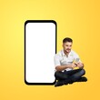Excited Man with Big Smartphone With Blank Screen And Using His Cell Phone,
