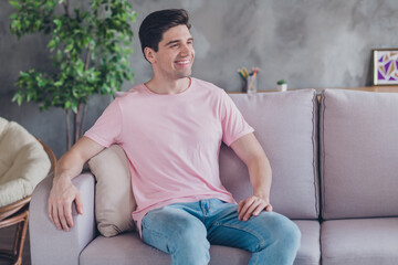 Canvas Print - Photo of dreamy cheerful guy sit couch look away enjoy rest wear casual outfit in comfortable apartment home indoors