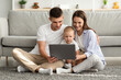 © Prostock-studio - Happy Young Parents And Their Toddler Baby Using Laptop Together At Home
