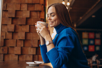 Potrait of woman holding a cup of coffee