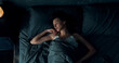 © Owl-vision-studio - Top view of beautiful young woman sleeping cozily in bed. Lady lying sound asleep at night. Loft interior.