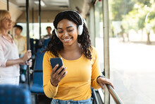 Happy Smiling Black Woman Listening Music In Bus