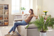 © Studio Romantic - Happy relaxed woman resting on comfy couch in modern interior of her own apartment. Young girl spending free time at home, enjoying quiet leisure, sitting on cosy sofa in living room. Comfort concept
