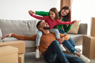 Poster - Portrait of happy Arab family having fun on moving day