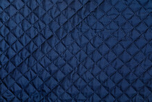 Blue Texture Of Puffer, Padded, Down Jacket. Background Of Urban Winter Outfit. Quilted Pattern