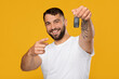 © Prostock-studio - Happy smiling mature handsome european guy in white t-shirt show finger at keys of new car