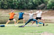 © Samuel Perales - Athletic group of people in sports clothes doing a yoga class in a park