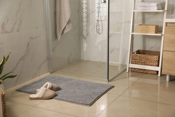 Poster - Soft grey bath mat and slippers on floor in bathroom