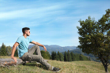 Canvas Print - Man enjoying beautiful mountain landscape on sunny day