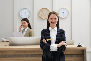 Poster - Portrait of beautiful receptionist near counter in hotel