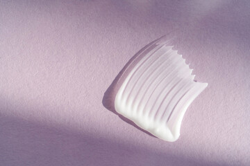 White cream texture on a purple background.