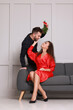 © New Africa - Lovely couple under mistletoe bunch near light grey wall indoors