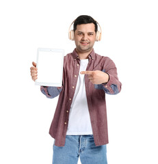 Wall Mural - Young man with tablet computer and headphones on white background