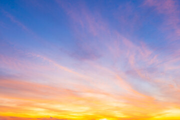 twilight blue bright and orange yellow dramatic sunset sky in countryside or beach colorful cloudsca