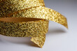 © Cynthia - Macro abstract texture background of sparkling gold color Christmas holiday glitter ribbon with bokeh and copy space