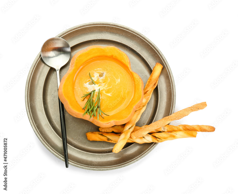 Tasty soup served in pumpkin with grissini on white background