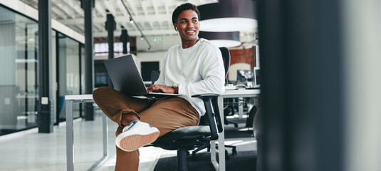 happy young programmer smiling while working