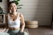 Mindfulness and meditation concept. Young asian woman doing workout at home, yoga meditation in living room on floor mat, getting focused
