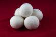 Pile of Tumble Dryer Balls on a Red Surface