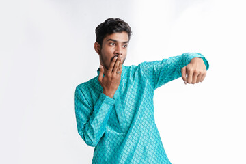 Indian man in tradition wear and giving expression on white background.