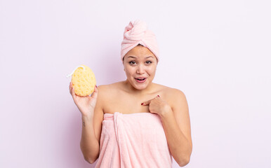 Wall Mural - hispanic pretty woman feeling happy and pointing to self with an excited. bathrobe and sponge concept